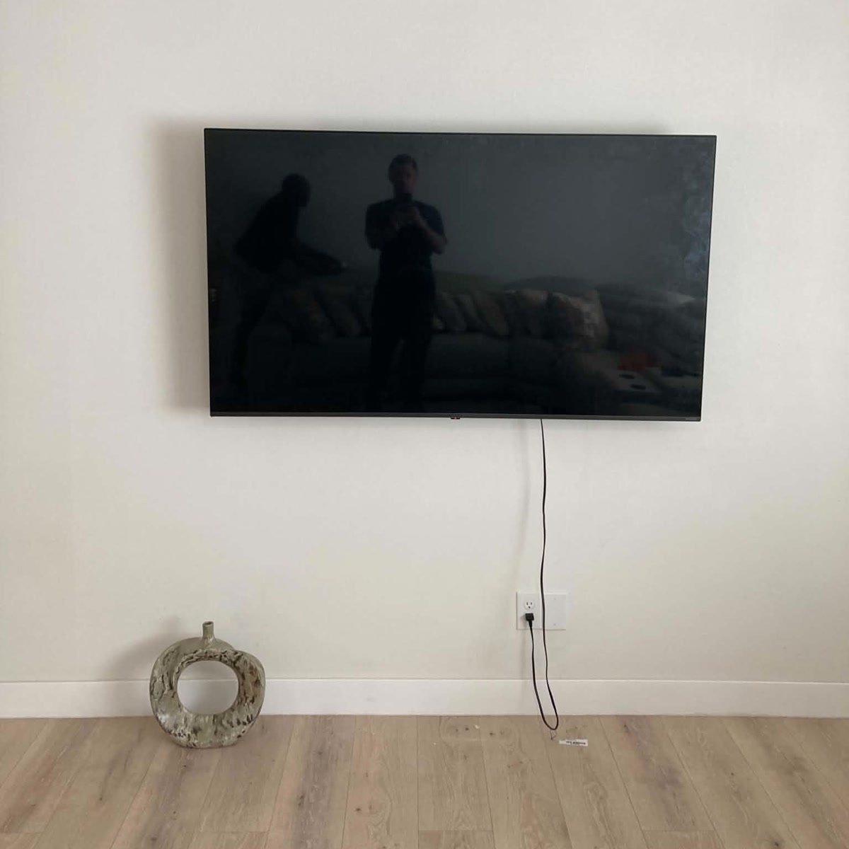 A large TV mounted level on a living room wall by Marshall's crew